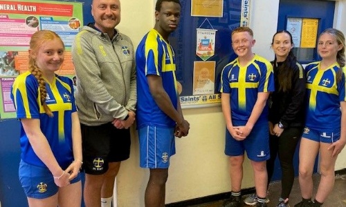 Photos of pupils and Head of PE Mr Parkes with the Gold Award by the School Games Mark